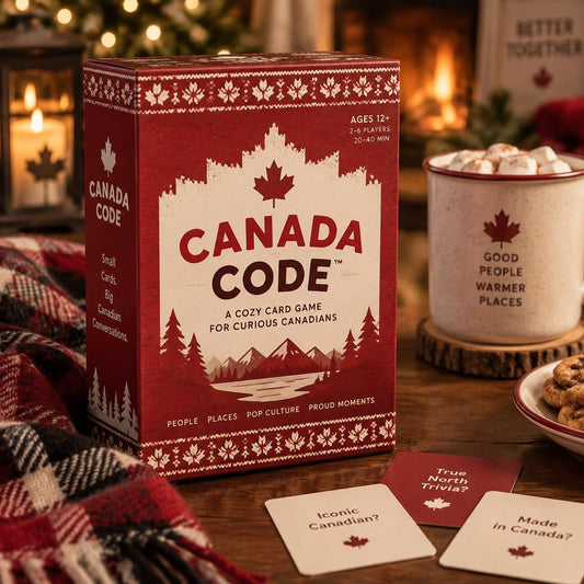 Canada Code card game box with a mug of hot cocoa and holiday decorations
