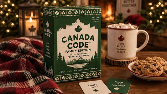 Canada Code Family Edition card game box next to a mug of hot cocoa